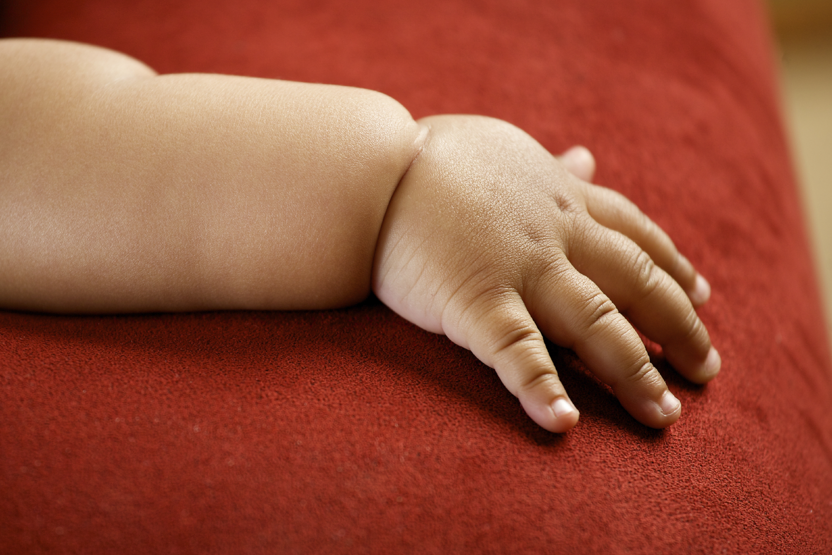 Children's hand isolated on red background